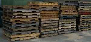 4 stacks of used wooden crates
